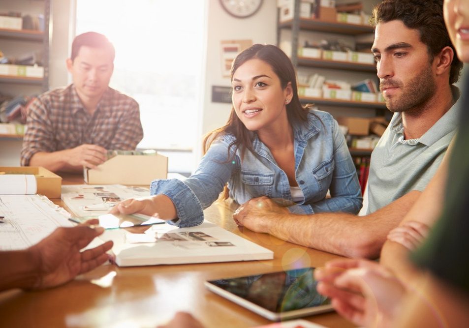 Five Architects Sitting Around Table Having Meeting